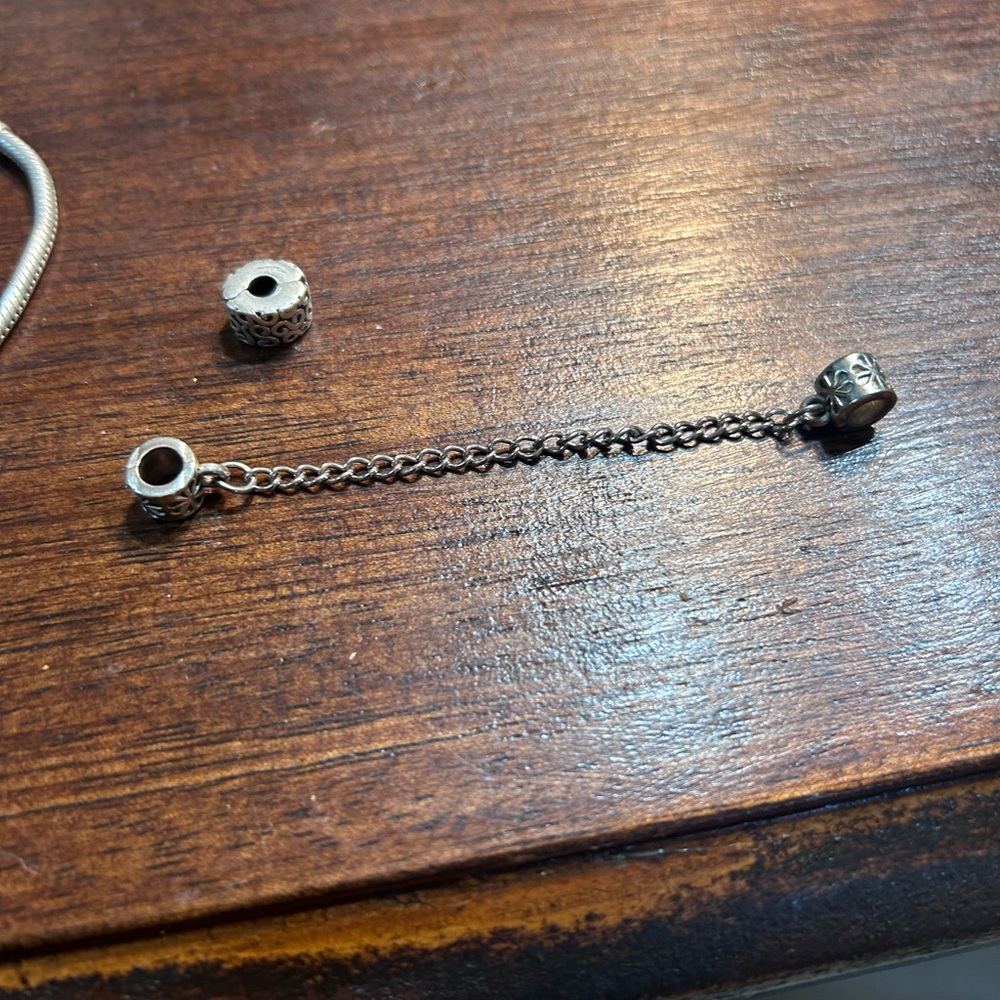 8.5 inch Pandora bracelet with safety clip and charm. Authentic
